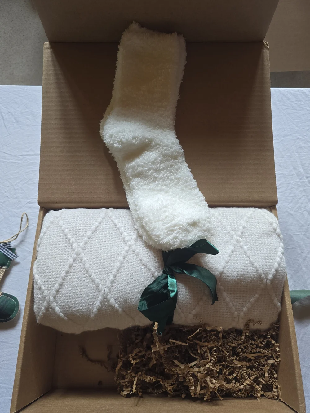 Holiday Home Gift Box with Cream Knit Throw and Green Ribbon Accents